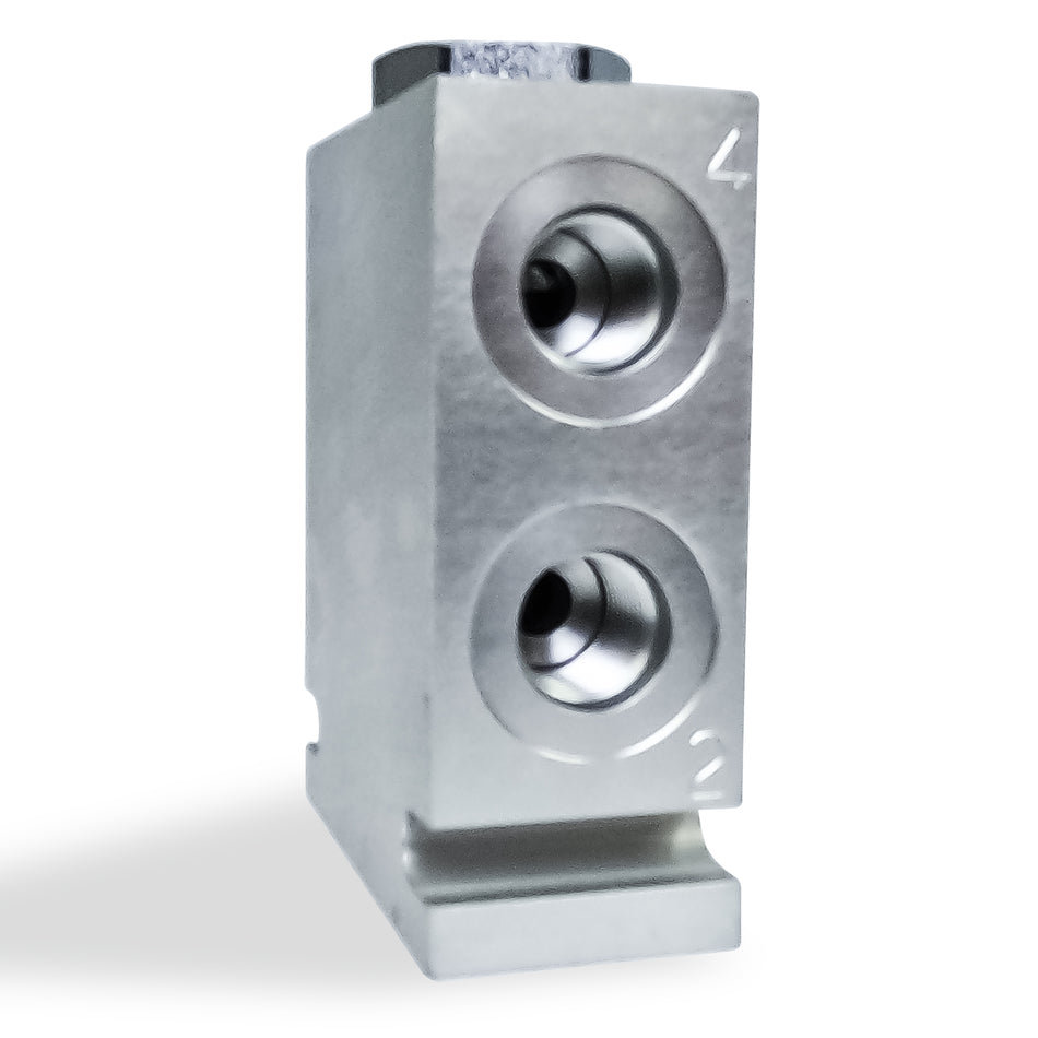 Hydraulic Pump Flow Divider: Close-up of a silver, perforated metal object, essential for synchronizing and balancing dual-acting hydraulic cylinders in high-pressure systems.